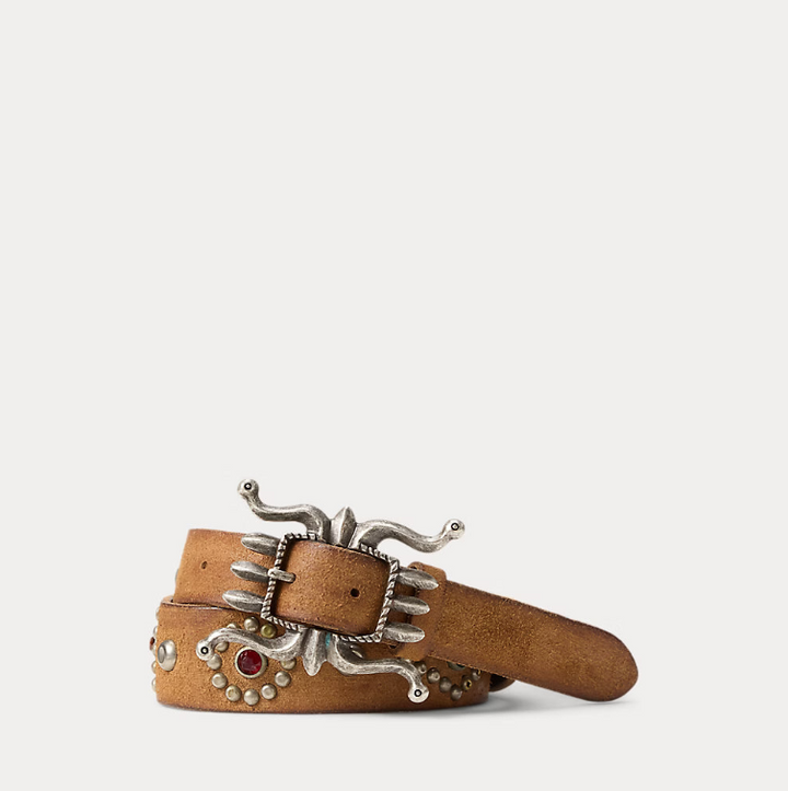 Brown belt with decorative silver buckle on a light gray background