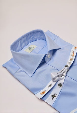 Light blue dress shirt with a collar and cuff on a light gray background