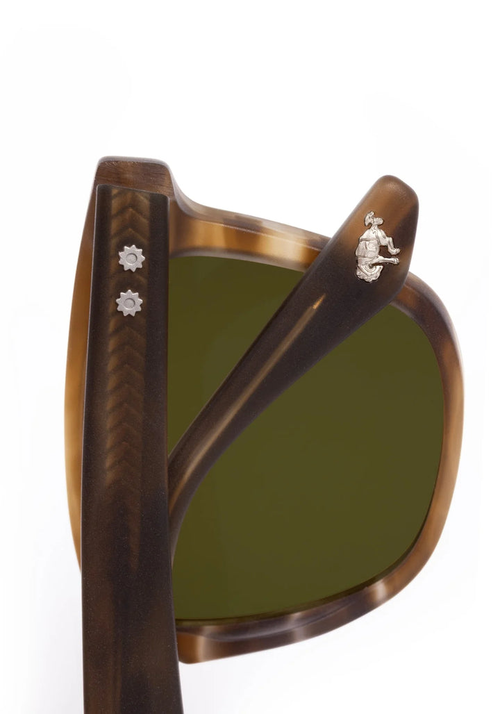 Brown sunglasses with green lenses on a white background