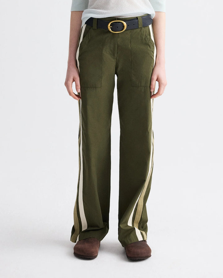 Person wearing olive green pants with white stripes on a white background