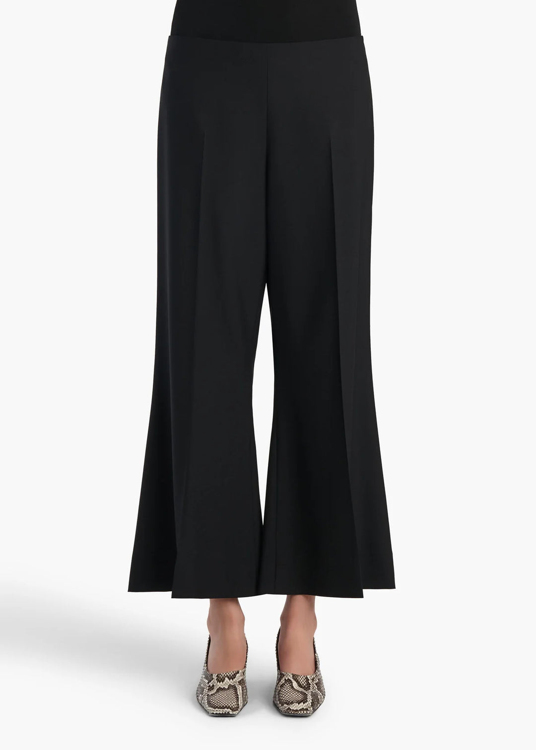 Black wide-leg cropped pants with a slight flare at the hem, shown on a model wearing snakeskin-patterned heels against a light gray background.