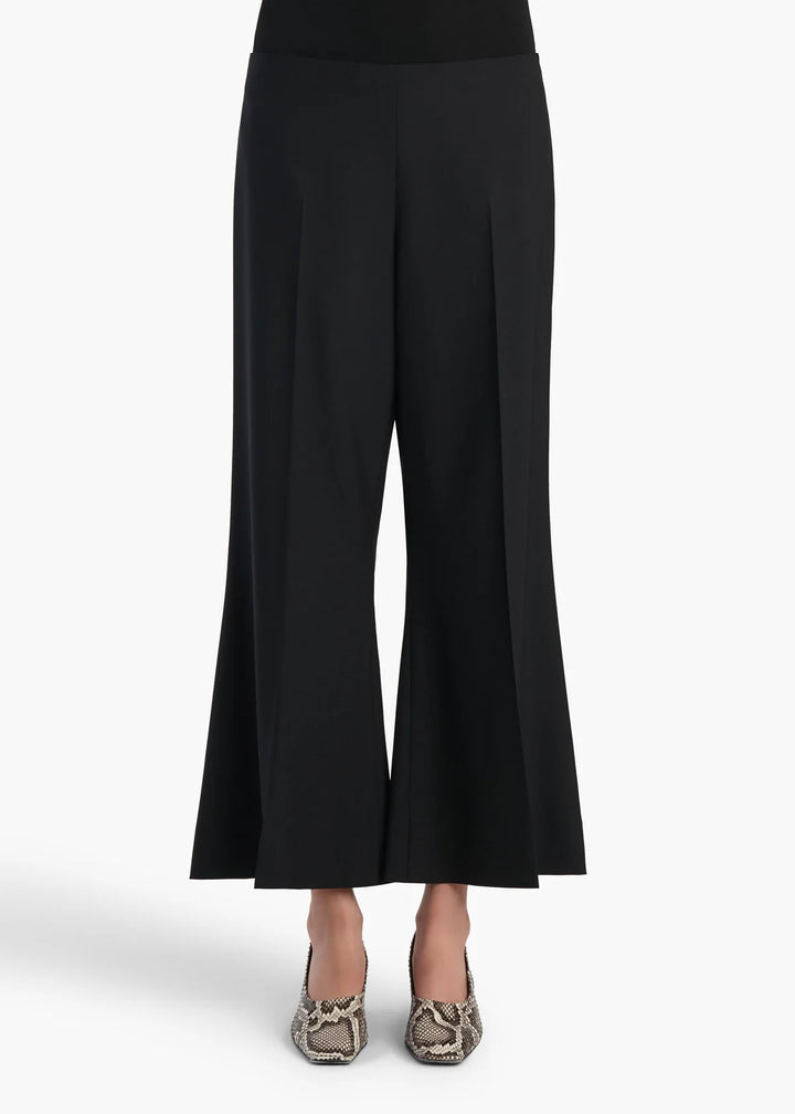 Black wide-leg cropped pants with a slight flare at the hem, shown on a model wearing snakeskin-patterned heels against a light gray background.