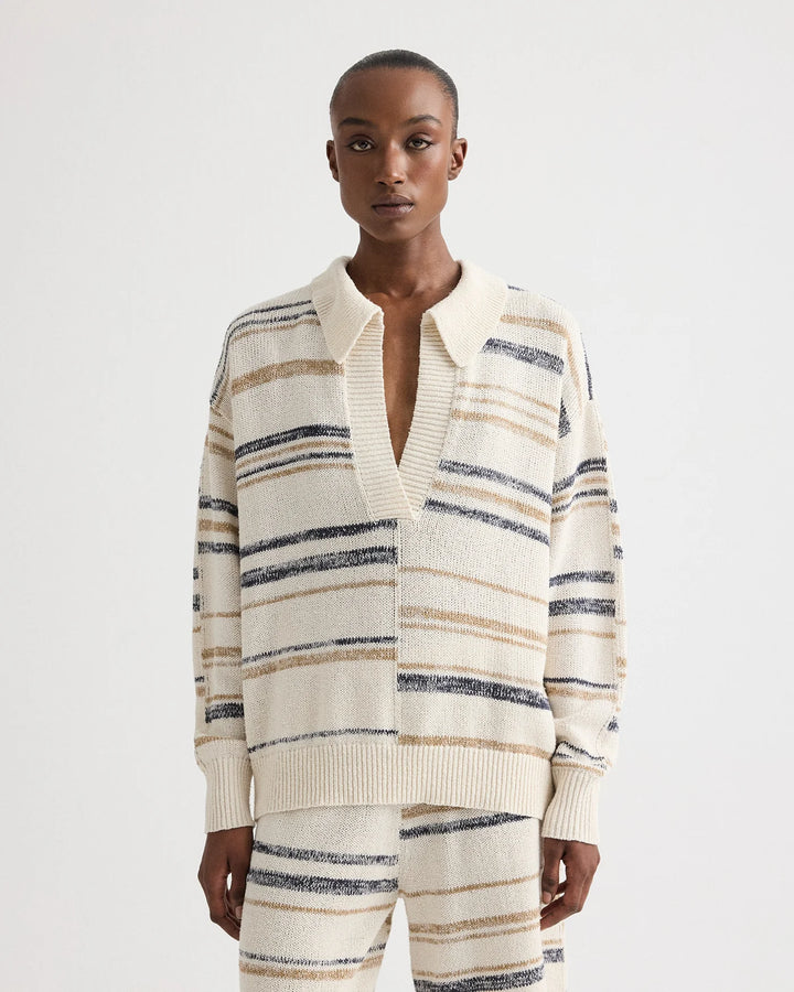 Person wearing a striped cardigan and pants on a white background