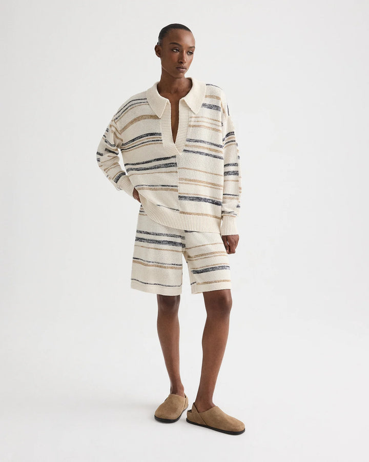 Person wearing a striped sweater and shorts set on a white background