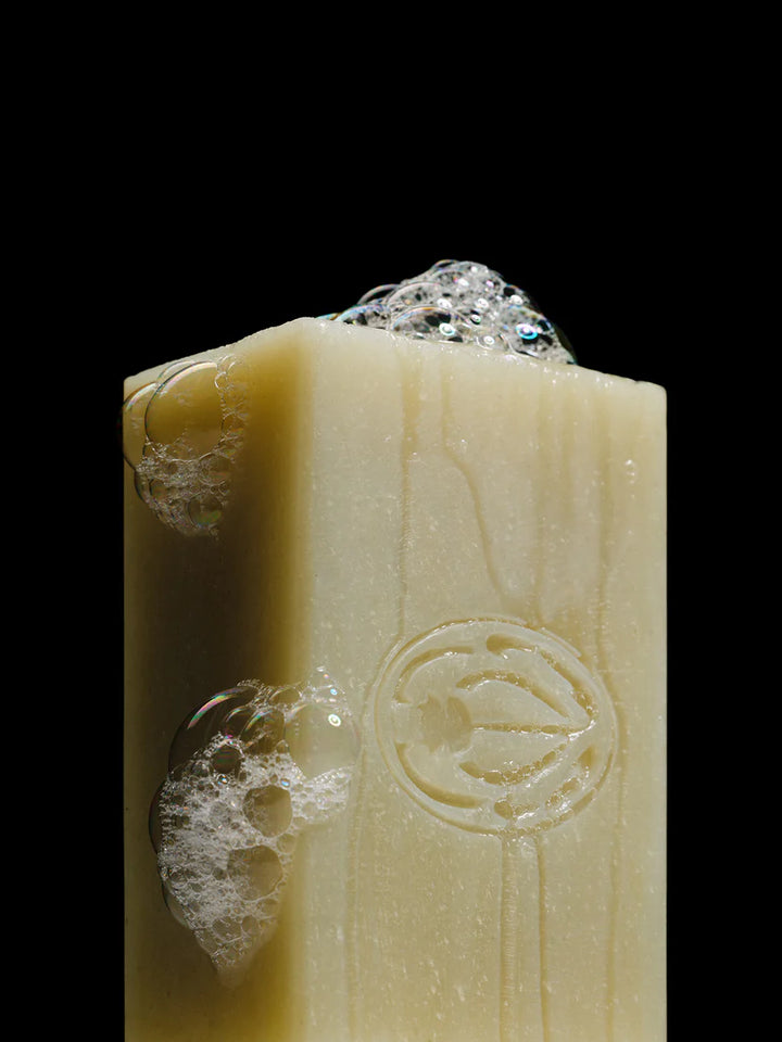Bar of soap with a brand logo on a black background