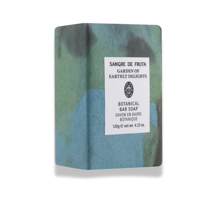 Bar of soap with a green and blue pattern and a visible label on a white background