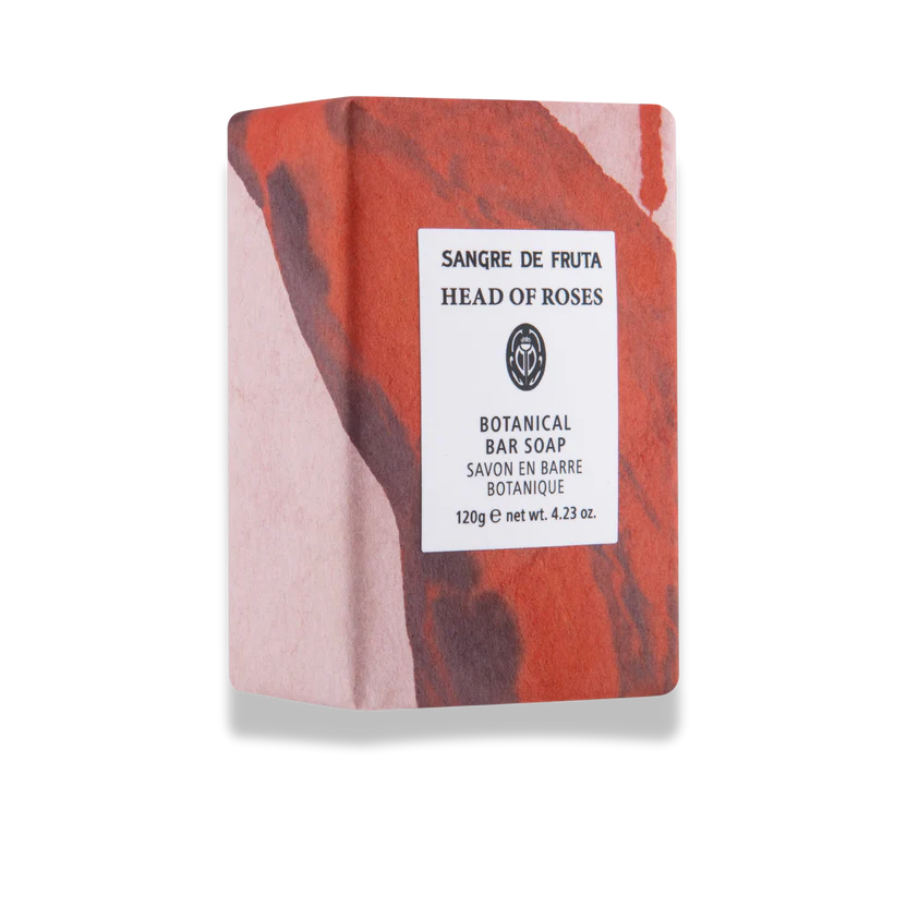Bar of soap with a marbled red and pink design on a white background