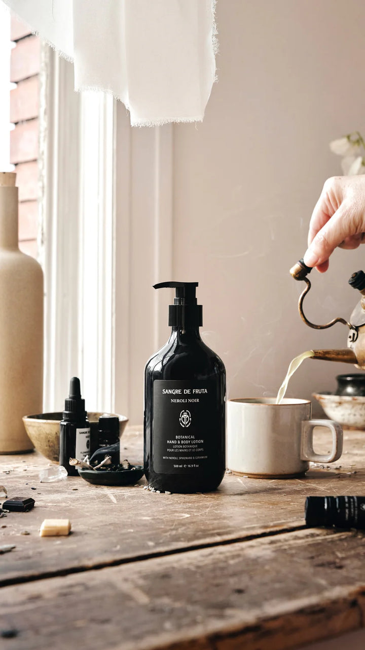 Black bottle with pump on a wooden table in a home setting