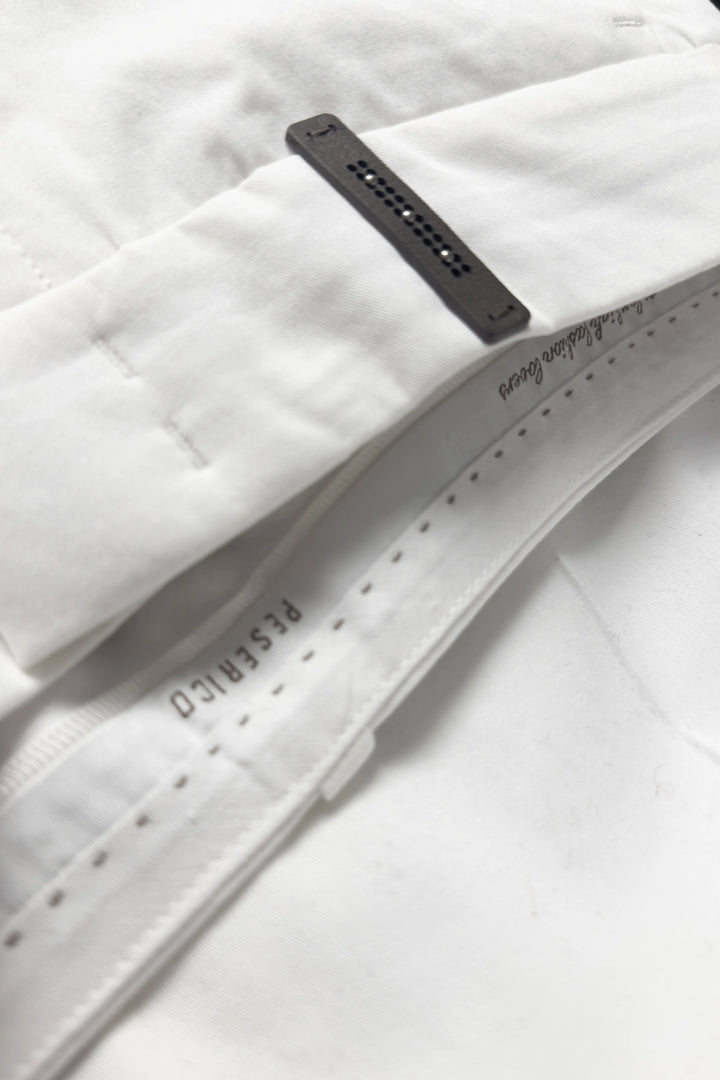 Close-up of a white belt with a black buckle on a white background