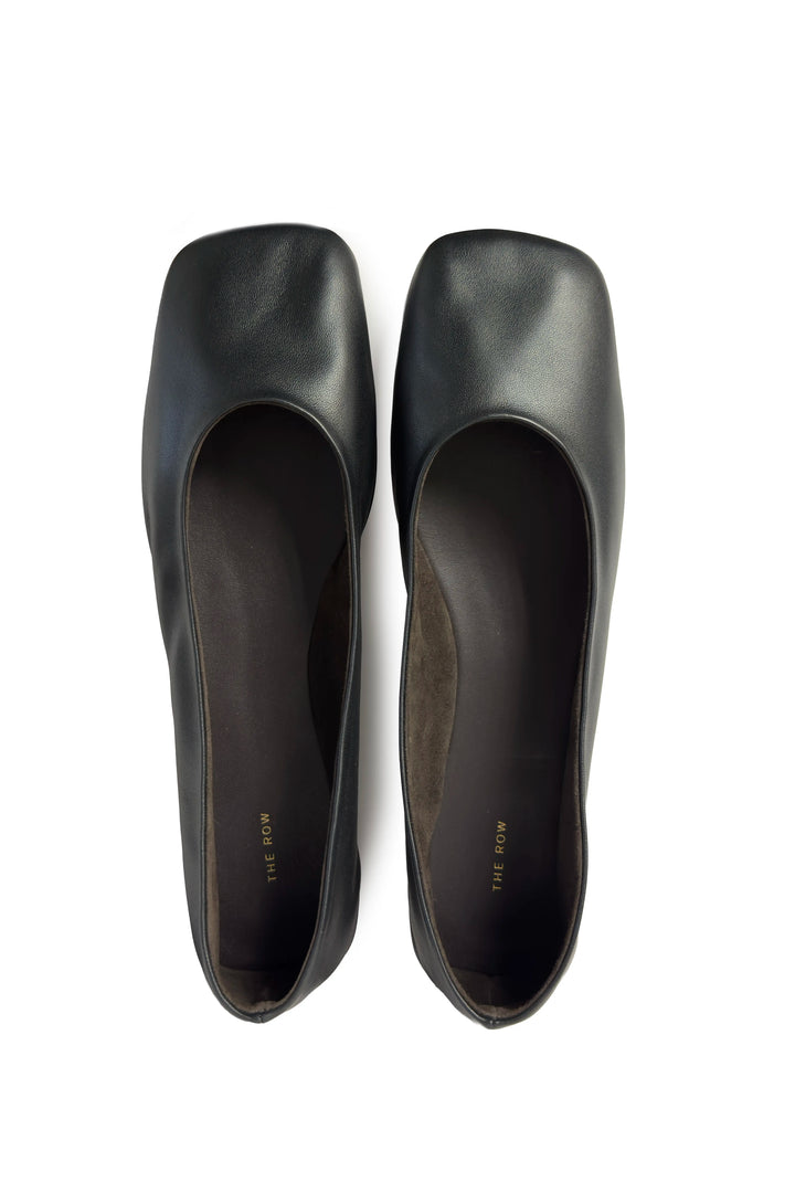 Pair of black high-heeled shoes on a white background