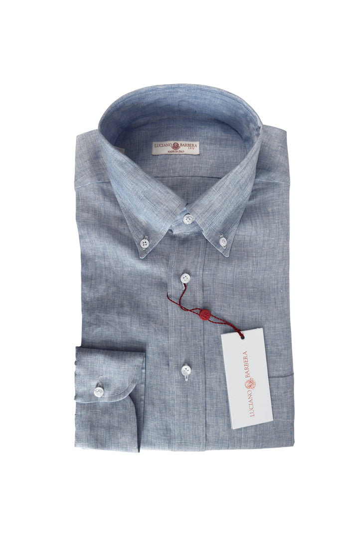 Folded blue shirt with a tag on a white background