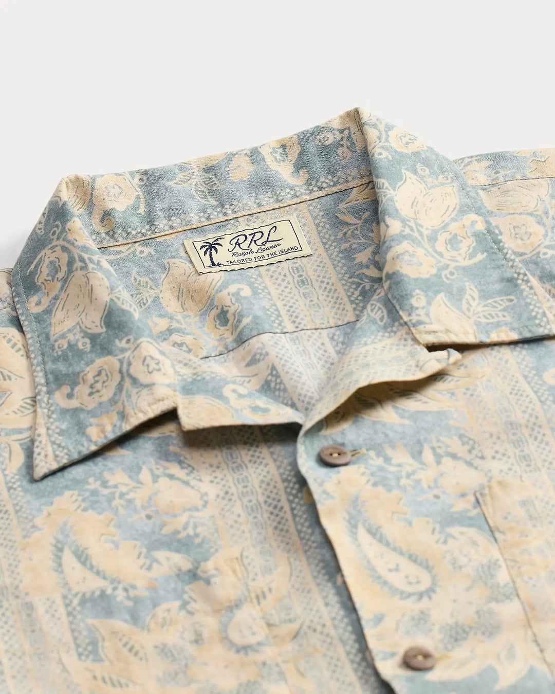 Patterned shirt with a visible brand logo on a light background