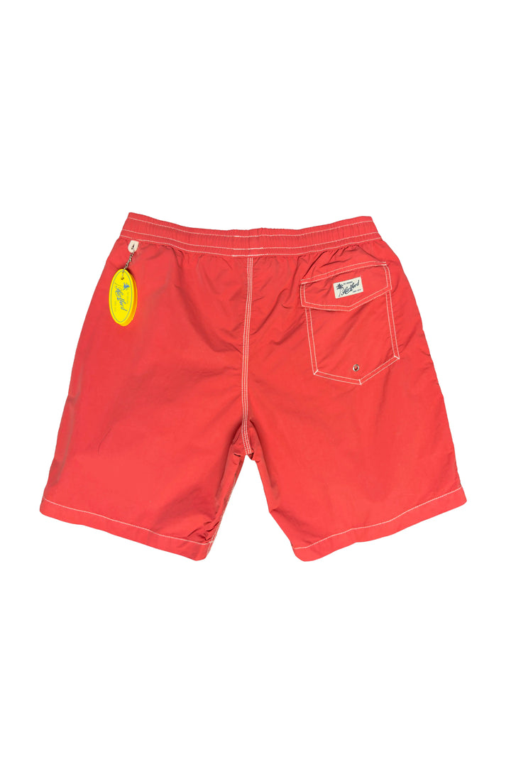 Red shorts with a tag on a white background