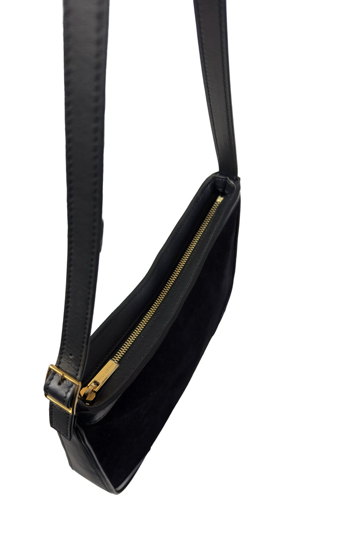 Black handbag with a gold zipper on a white background