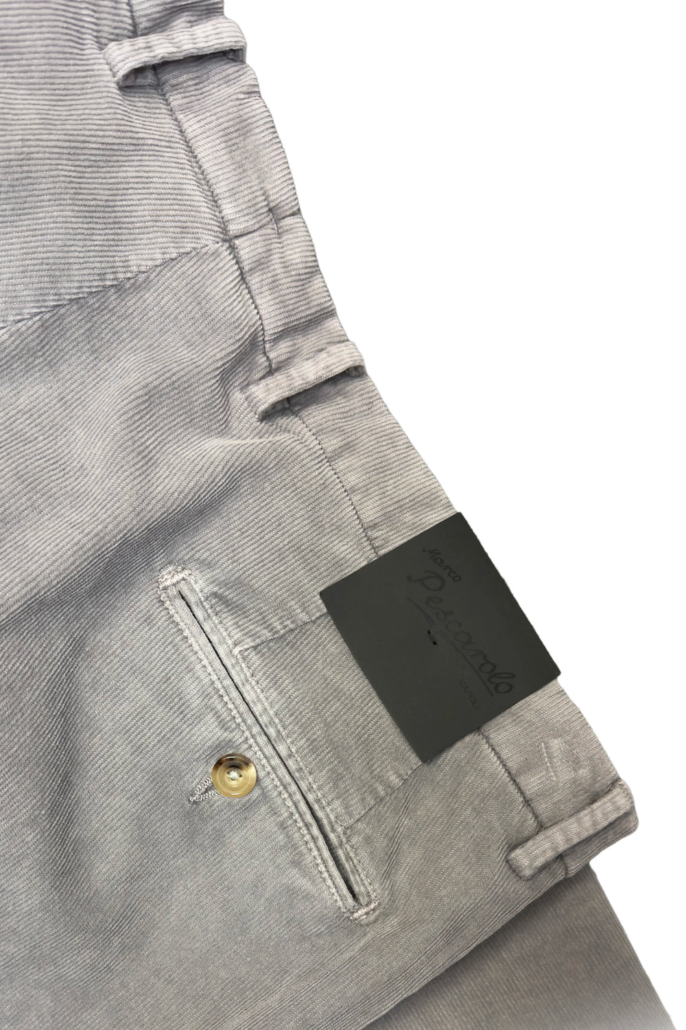 Close-up of a gray corduroy jacket with a brand label on a white background
