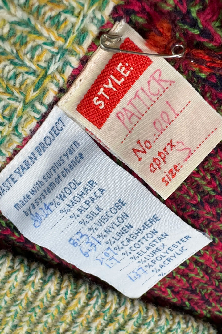 Textile label with yarn composition details on a multicolored fabric background