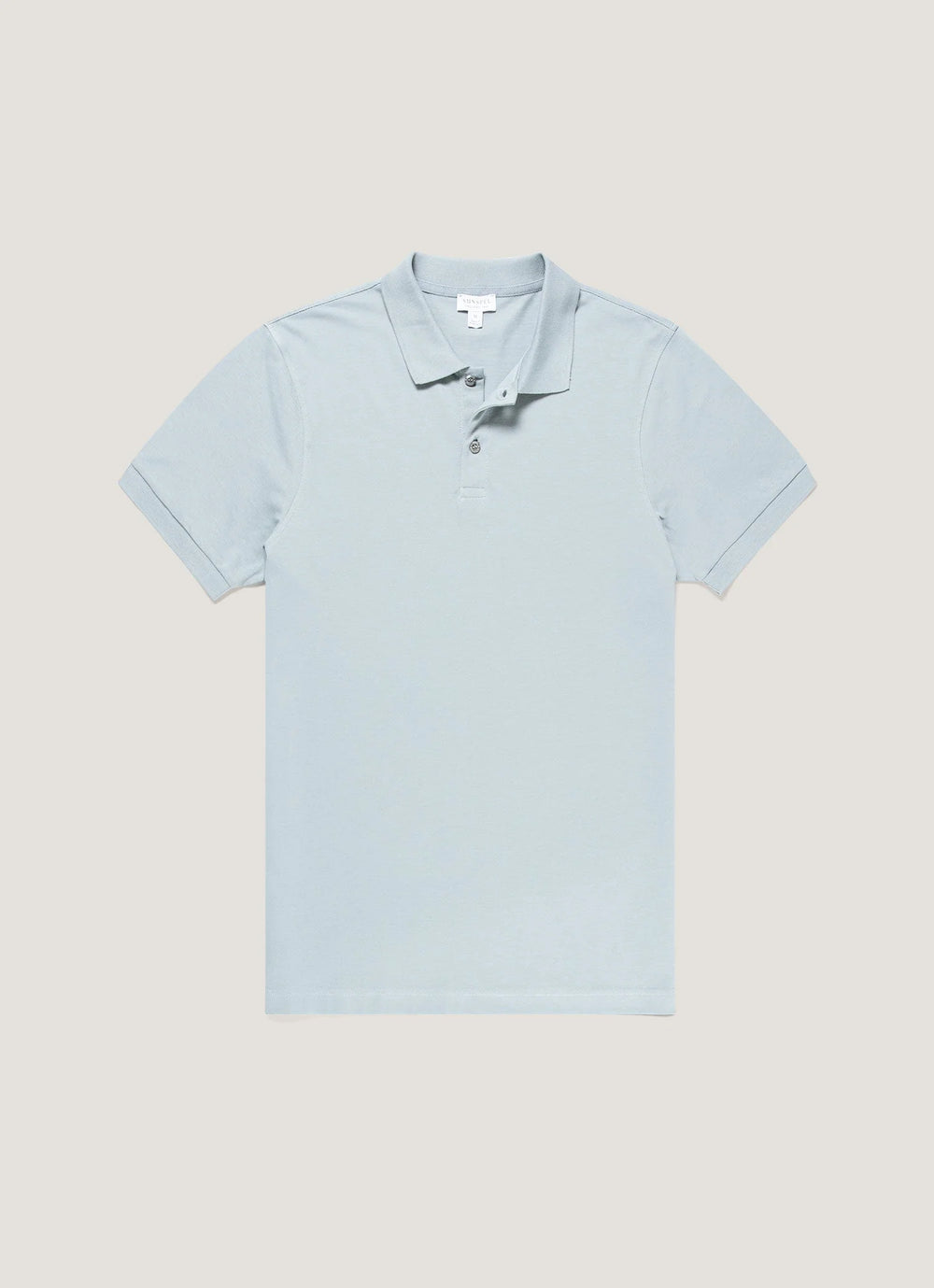 Light blue polo shirt on a beige background