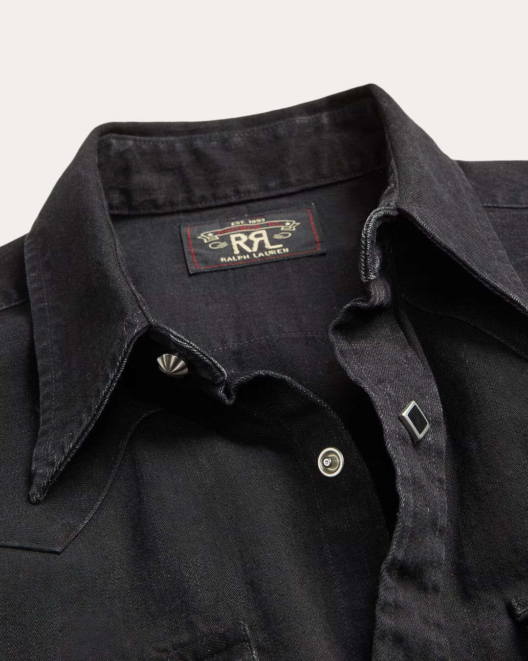 Close-up of a black denim shirt with a Ralph Lauren logo on a light gray background