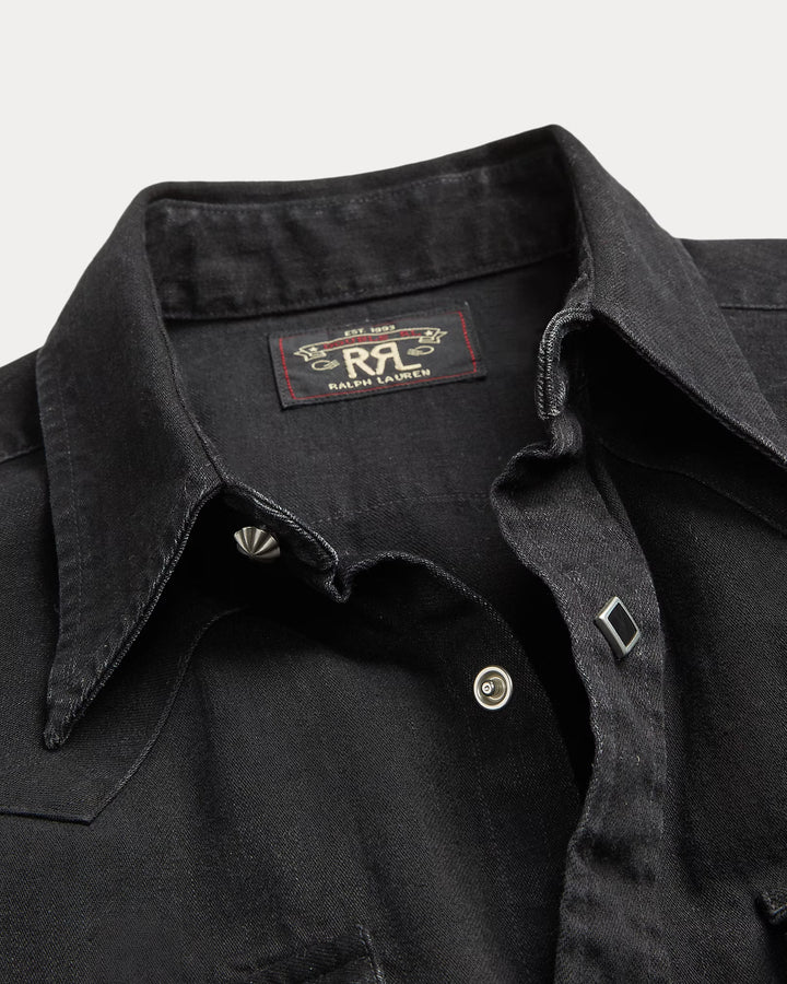 Close-up of a black denim shirt with a Ralph Lauren logo on a light gray background