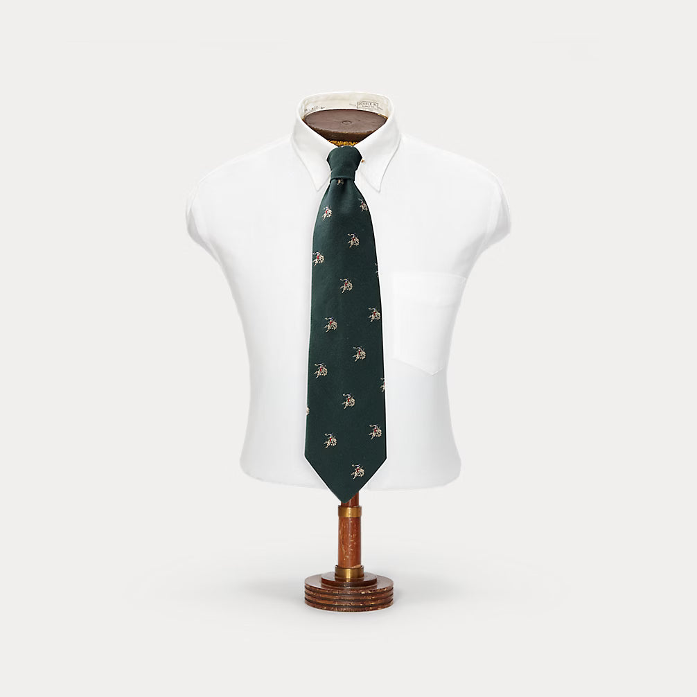 Green patterned tie on a mannequin with a white background