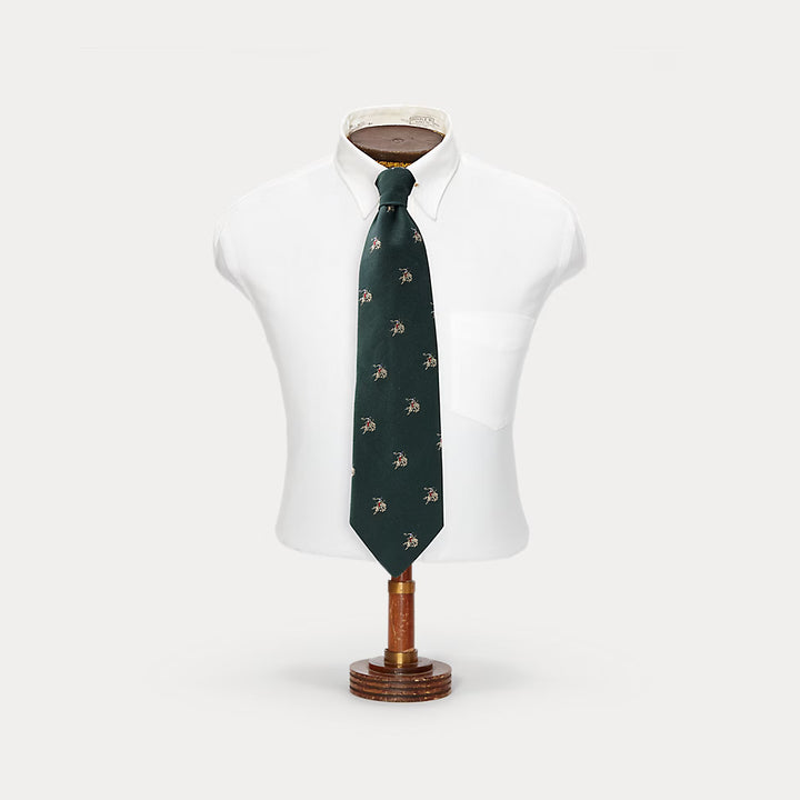 Green patterned tie on a mannequin with a white background