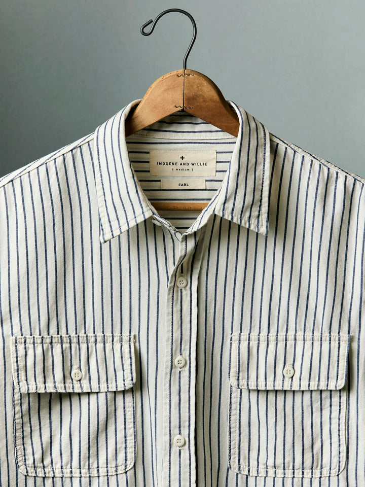 Striped shirt on a hanger against a gray background