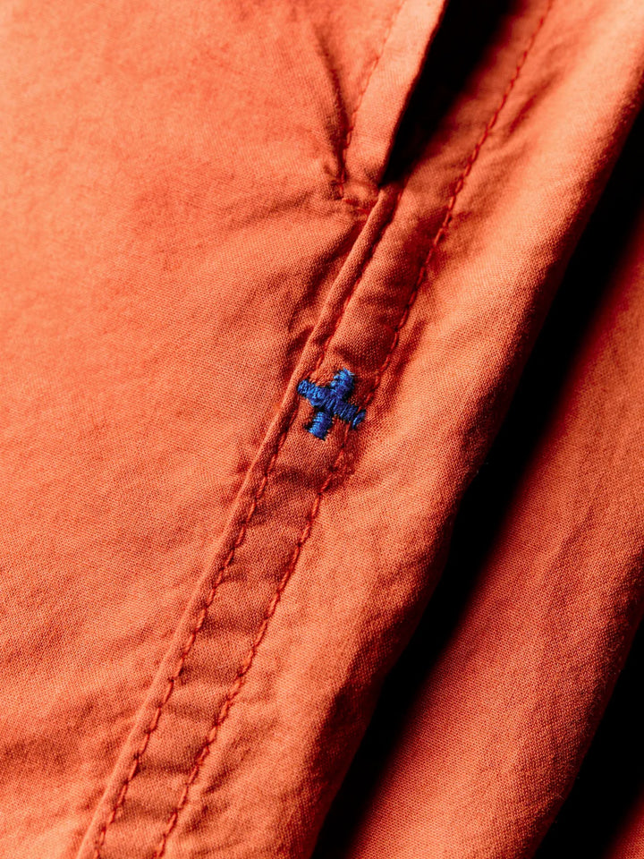 Close-up of a red fabric with a blue button