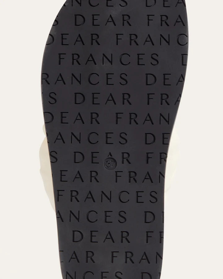 Black flip-flop sandal with 'Dear Frances' text pattern on a white background